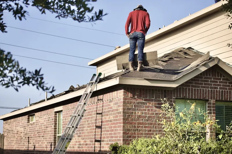 Professional roofer working on a residential roof in County Line